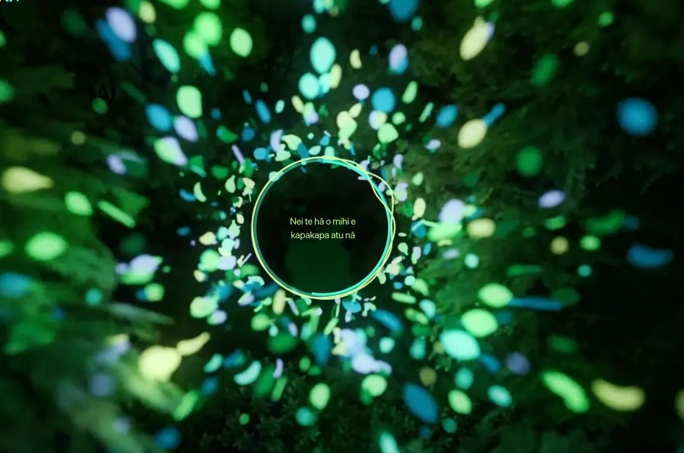 Green, and blue confetti rushes towards the viewer around text in te reo Māori.